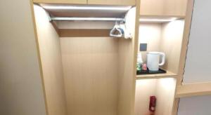 a door to a room with a cupboard with aperature at Zhenxing Hotel in Shenzhen