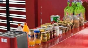 a counter with jars of food and bottles of orange juice at G4 Station Backpackers Hostel in Singapore