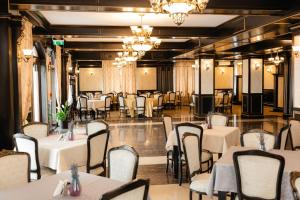 a banquet hall with white tables and chairs at Hotel Ambasador Iasi in Valea Lupului