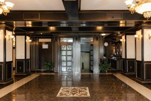 an empty lobby with a door and a floor at Hotel Ambasador Iasi in Valea Lupului +87 photos