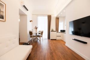 a living room with a white couch and a table at Palazzo del Poeta - Dimora Contemporanea in Palermo +257 photos