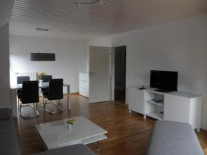 a living room with a couch and a table at Appartement bei Kiel in Lilienthal