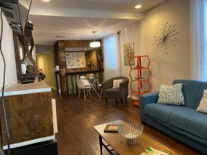 a living room with a blue couch and a table at Steps into the French Quarter in New Orleans