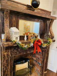 a fireplace with christmas wreaths on it at Steps into the French Quarter in New Orleans