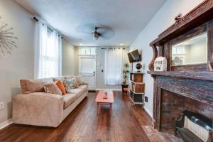 a living room with a couch and a fireplace at Steps into the French Quarter in New Orleans