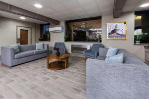 a living room with two couches and a table at Americinn by Wyndham Appleton Downtown in Appleton