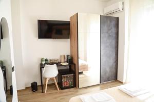 a mirror in a room with a chair and a bed at Affittacamere Brezza Di Sirolo in Sirolo