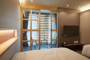 a hotel room with a bed and a television at Royal Square Hotel Seoul in Seoul +44 photos