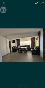 a living room with two couches and a table at Pensiunea LA ANI in Vadu