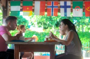 a group of people sitting at a table with flags at Bonito HI Hostel e Pousada in Bonito