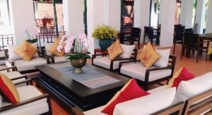 a room with a bunch of couches and flowers at Doltara Boutique Resort in Chiang Mai