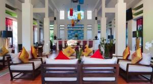 a lobby with couches with colorful pillows on them at Doltara Boutique Resort in Chiang Mai