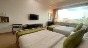 a hotel room with two beds and a window at Grand Harbour Hotel in Macau +134 photos