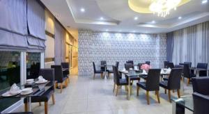 a dining room with tables and chairs in a restaurant at Phuglong Hotel in Phayao