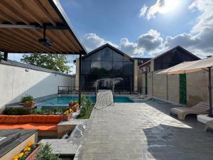 a house with a swimming pool and a patio at Qafqaz Suite Wood Stack in Gabala