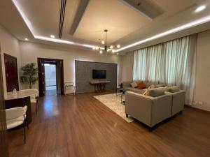a living room with a couch and a table at شير فل الرس in Ar Rass +15 photos
