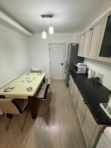 a small kitchen with a table and a counter top at Nova Stay Craiova in Craiova