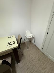a room with a table and two chairs and a table at Nova Stay Craiova in Craiova