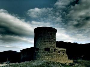 a brick tower sitting on top of a hill at Rooms Putnik in Senj +10 photos