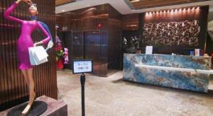 a mannequin in a pink dress in a lobby at Ehotel in Hong Kong