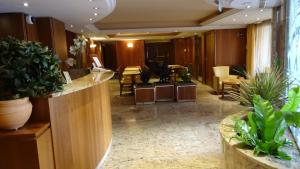 a lobby with potted plants in a hotel room at Residence Club Inn in Nice