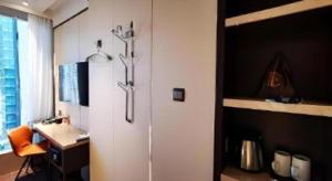 a white refrigerator in a room with a desk and a window at Ehotel in Hong Kong