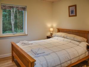 a bedroom with a large bed and a window at Chestnut Cottage - Uk48294 in Great Yarmouth +16 photos