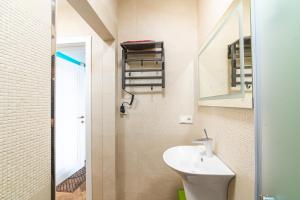 a small bathroom with a sink and a mirror at Великі котеджі з терасами у моря Совіньйон in Odesa +71 photos