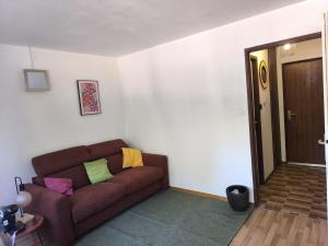 a living room with a brown couch with colorful pillows at Turckheim in Turckheim