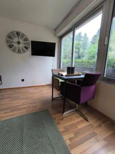a room with a table and a clock on the wall at Turckheim in Turckheim