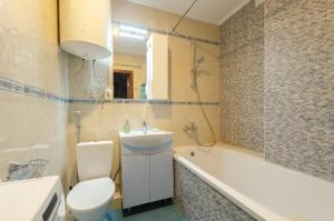 a bathroom with a toilet and a sink and a tub at Apart with Panorama View Позняки Харьковская in Kyiv