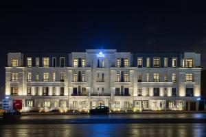 a white building with a blue star on top of it at Amber Hospitality - Blvd in Riyadh