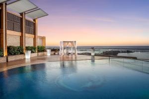 a swimming pool with a tent and a view of the ocean at Hilton Alexandria Corniche Hotel in Alexandria