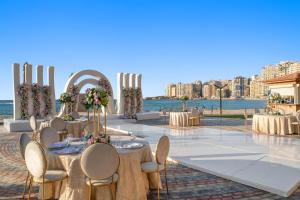 a wedding reception with tables and chairs and the water at Hilton Alexandria Corniche Hotel in Alexandria