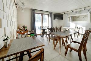 a dining room with wooden tables and chairs at VILLA NOSAL - Zakopane in Zakopane