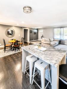a kitchen and living room with a large marble counter top at Tucked away in Tucker in Tucker