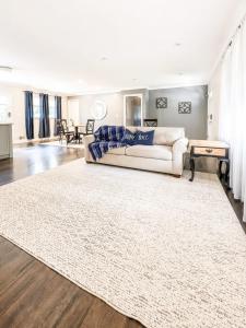 a living room with a white couch and a rug at Tucked away in Tucker in Tucker
