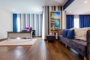 a living room with a couch and a piano at Modern House Uprompt Chiangmai in Chiang Mai