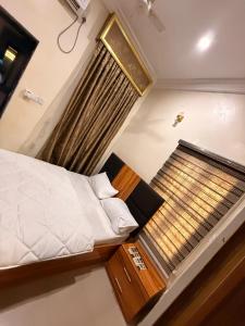 a small bedroom with a bed and a window at Mario Suites Ltd in Kano +3 photos