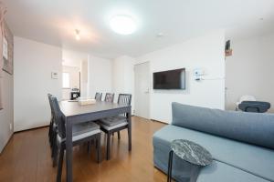 a living room with a table and a couch at FUJIMI TOWN HOUSE in Tokyo