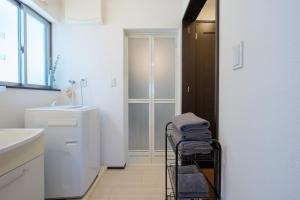 a laundry cart with towels on it in a kitchen at FUJIMI TOWN HOUSE in Tokyo +44 photos