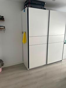 a white closet with a sliding door in a room at Steve's Condo in Davao City