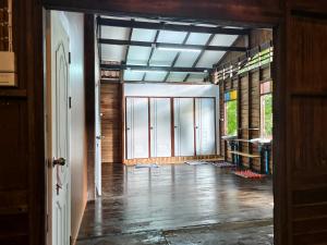 an open hallway with a room with glass doors at Thanomrak homestay in Ban Pha Saeng Lang
