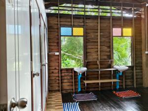 a bathroom with two sinks and two windows at Thanomrak homestay in Ban Pha Saeng Lang