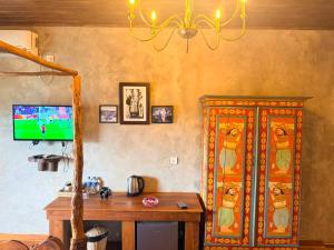 a living room with a tv and a wooden table at Negombo Boutique Villa in Negombo