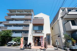 a building with a bike parked in front of it at FUJIMI TOWN HOUSE in Tokyo