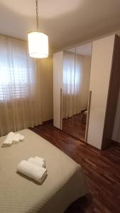 a bedroom with a bed and a mirror with towels on it at Casa FerGi in Amandola