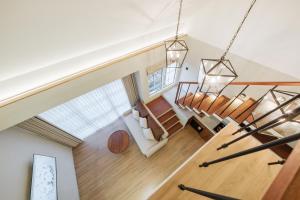 an overhead view of a living room with wooden floors and stairs at Nuho Living in Bingin Beach