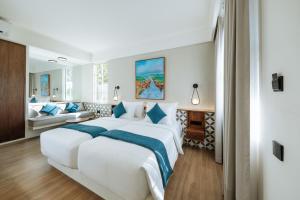 a hotel room with two beds and a couch at Nuho Living in Bingin Beach +36 photos