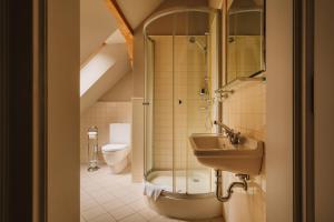 a bathroom with a sink and a shower and a toilet at Villa Titina in Miedzygorze +109 photos